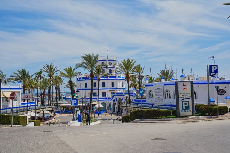 View of the harbour in Estepona with blue and white colored buildings